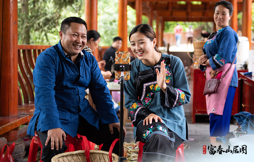 在湘西十八洞村，十八洞村扶貧隊長與返鄉(xiāng)大學生一起直播推銷土特產。